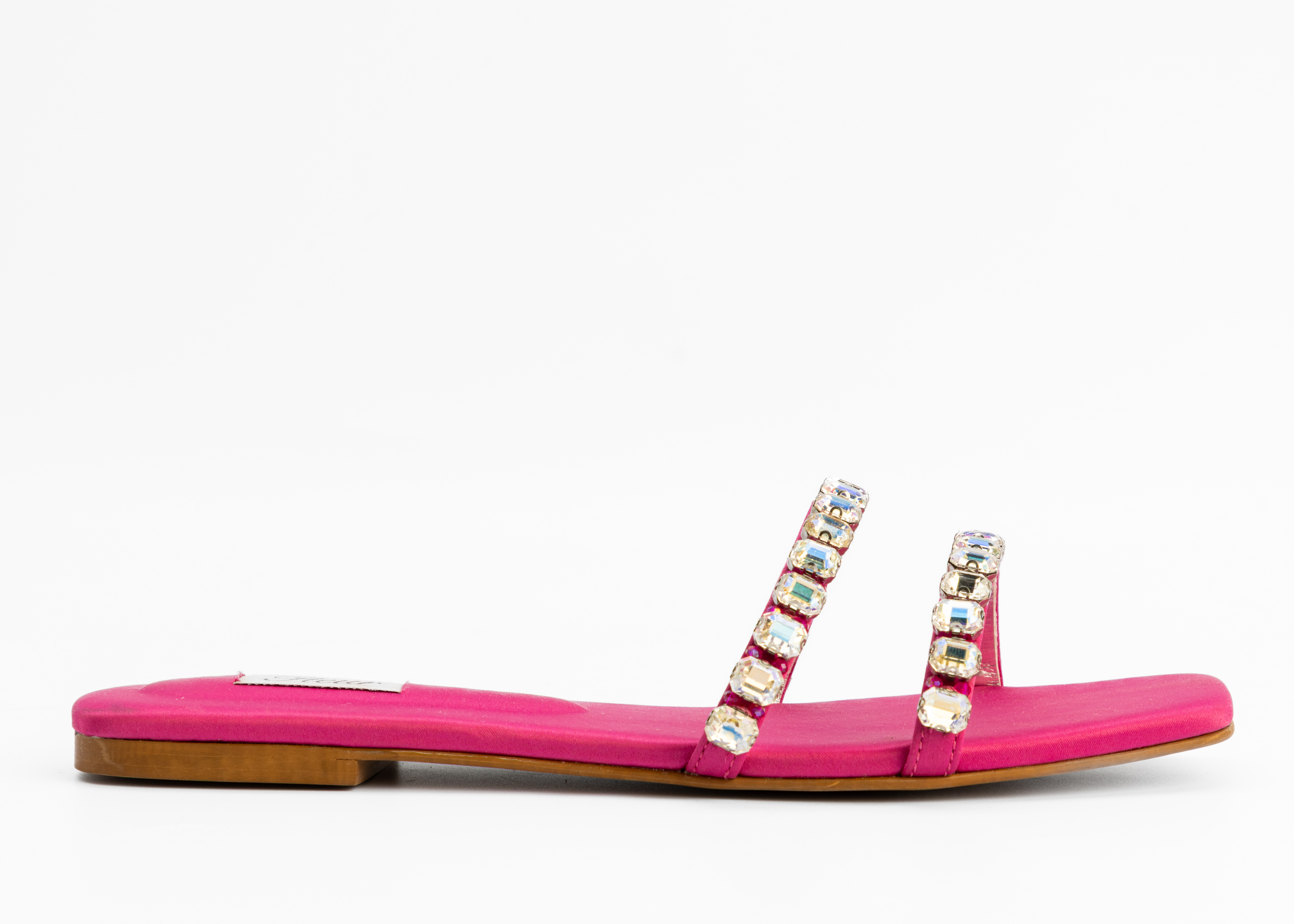 Pink sandal with embellished straps on a white background